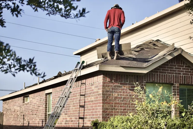Professional roofer working on a residential roof in Chesterfield Gardens